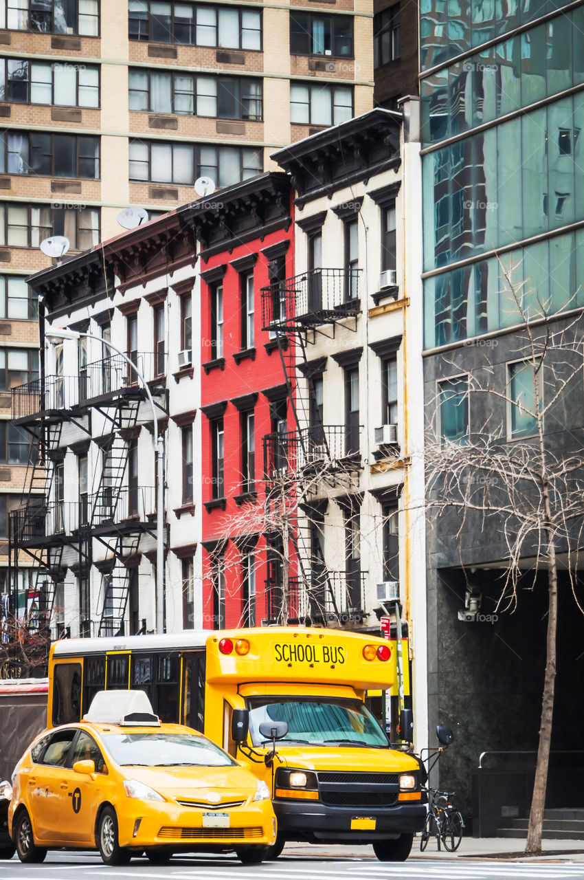 School bus and yellow cab in the streets of New York 