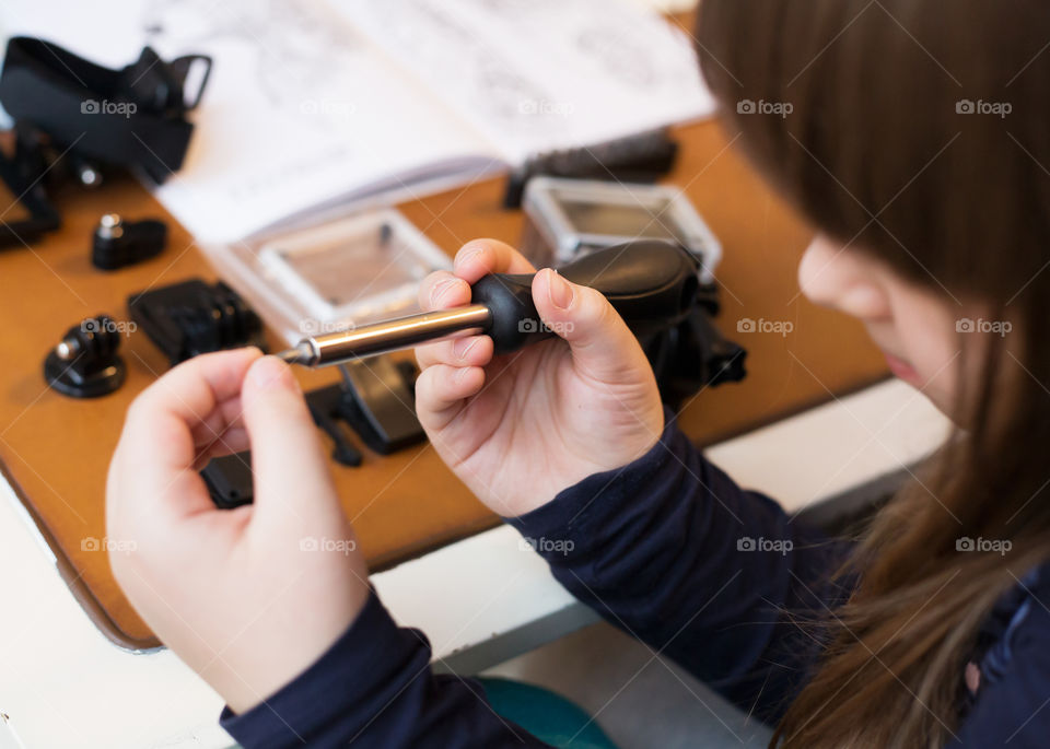 Little girl with screwdriver