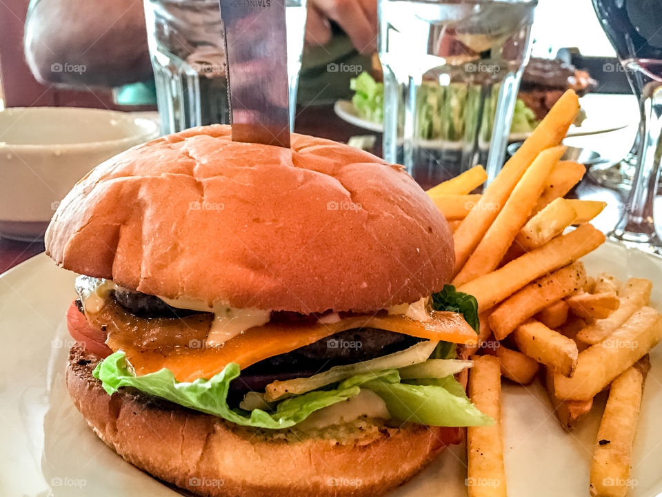 Gourmet hamburger and chips French fries closeup 