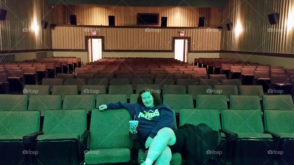 Portrait of a woman sitting in empty theater