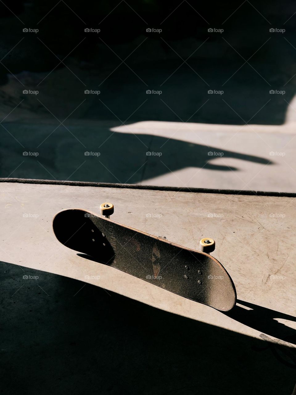 One lonely skateboard on a sunny day 