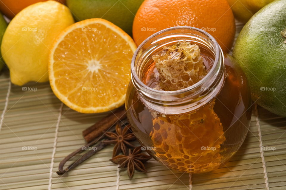 Close-up of honey with spices and citrus fruits