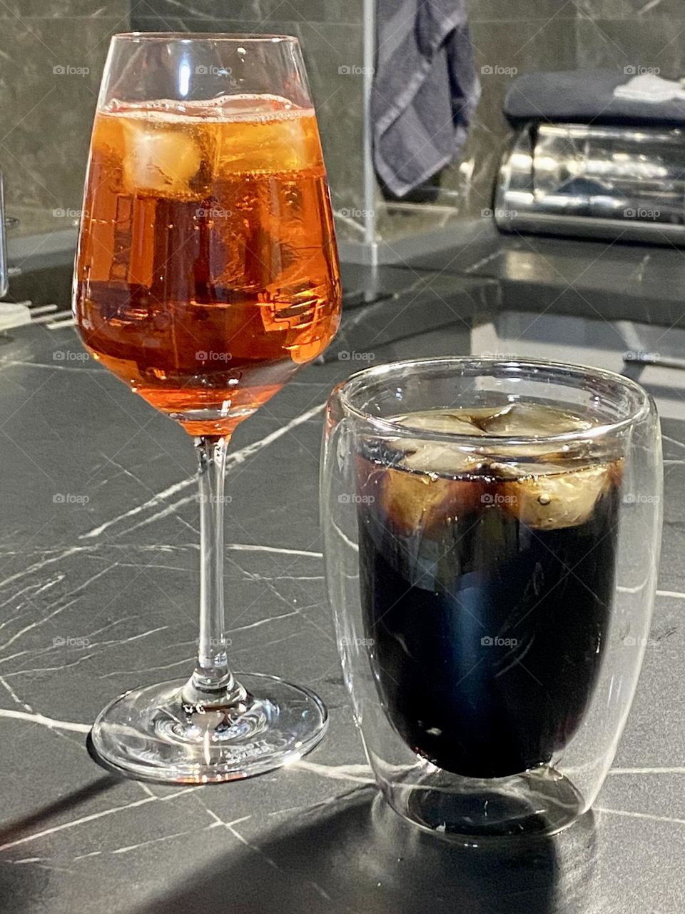 Aperol spritz iced cocktail and glass with Coca Cola