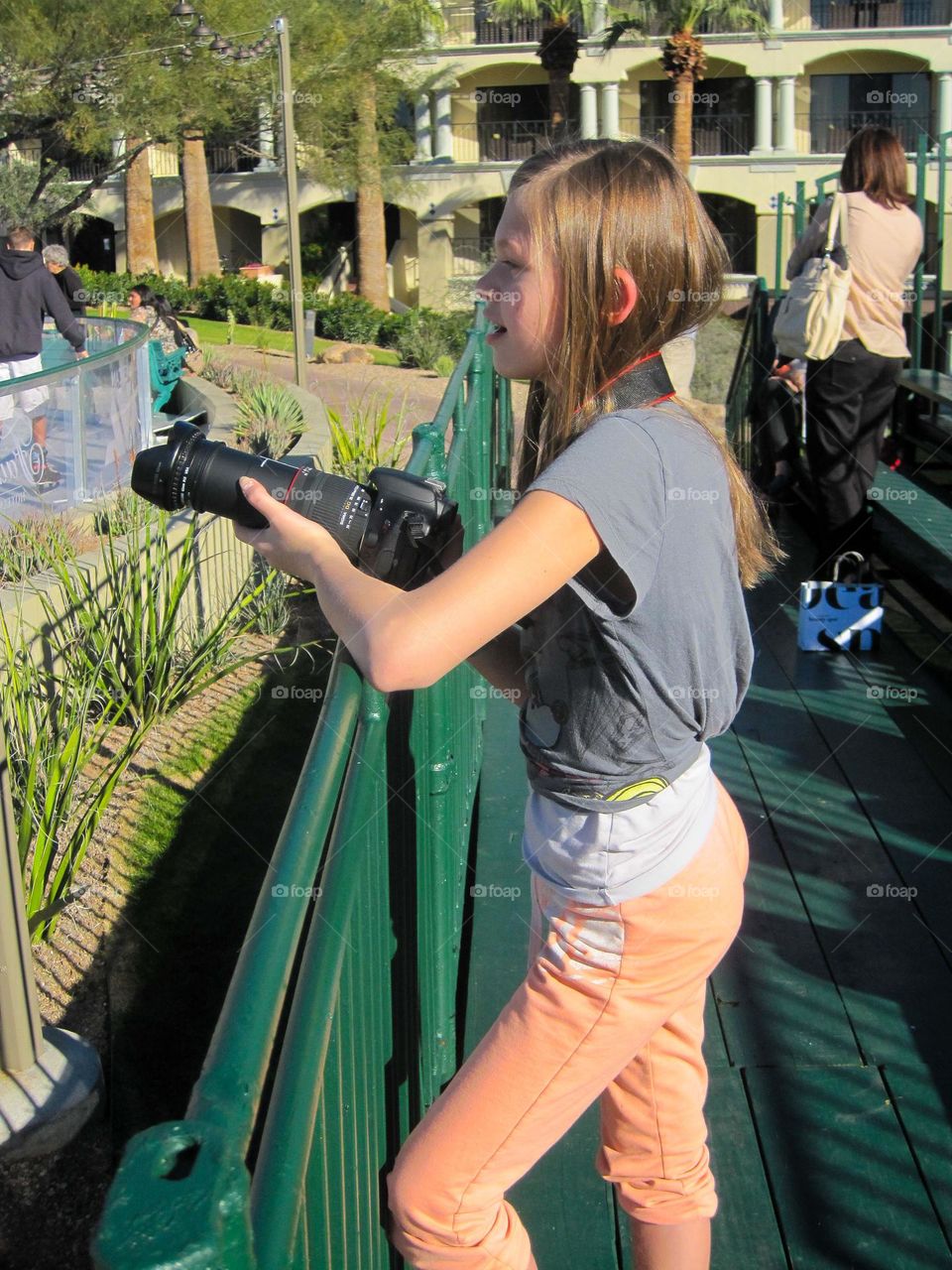 Young girl ready to take amazing photographs at ice rink