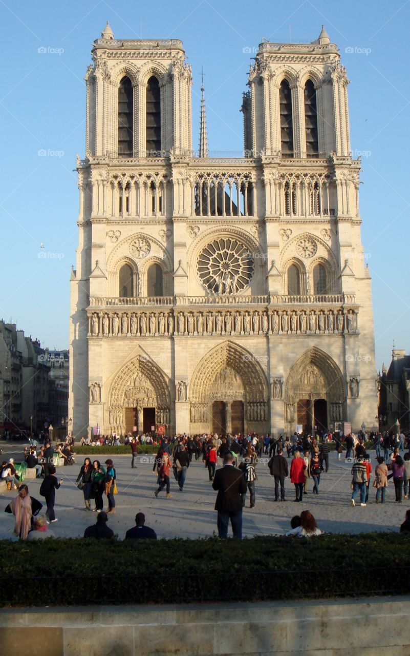 facade of Notre Dame Cathedral full of people walking