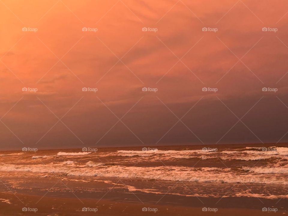 Unedited beautiful orange sky on the beach in North Carolina on bird island at dusk.