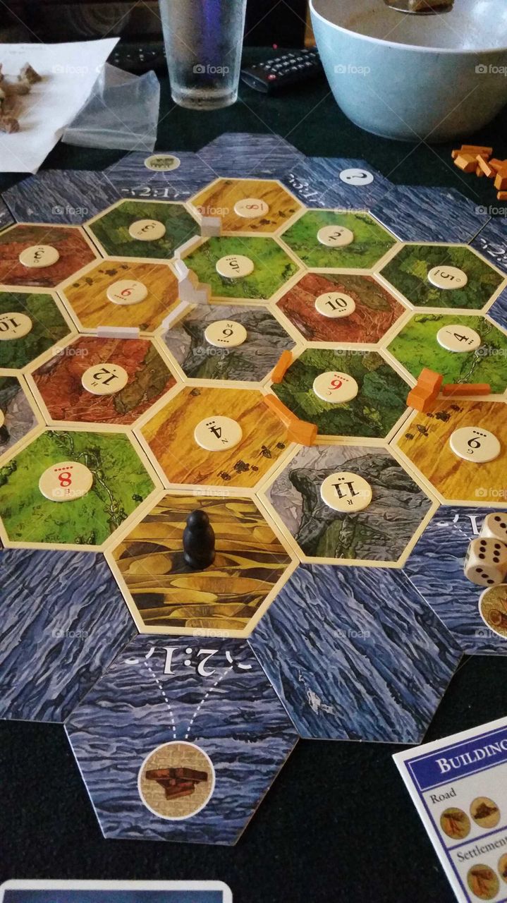 boardgame with snacks that are required for a long duration game of  "settlers of catan"