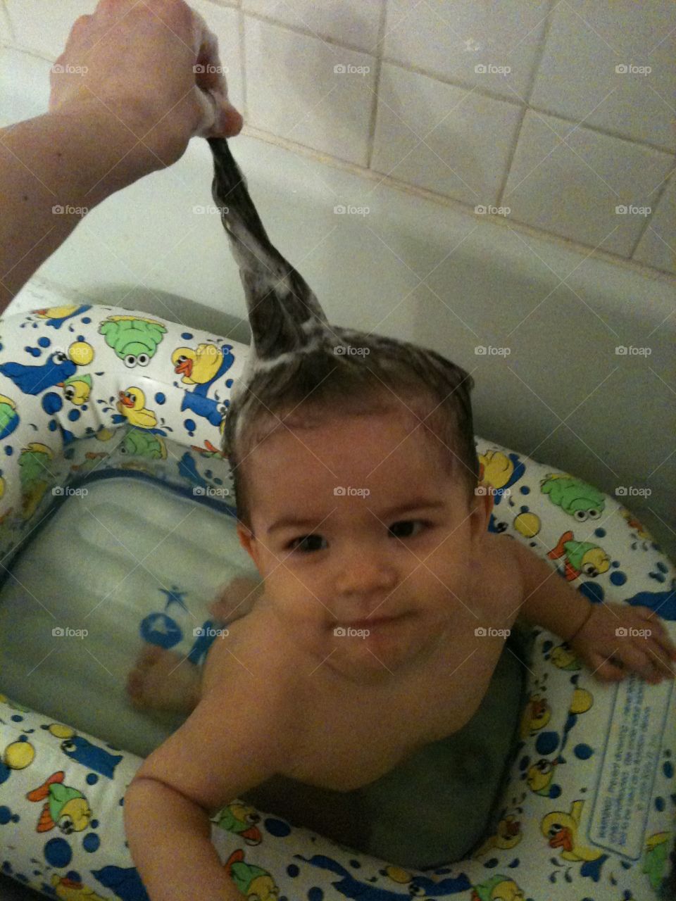 One year old bath time with long hair