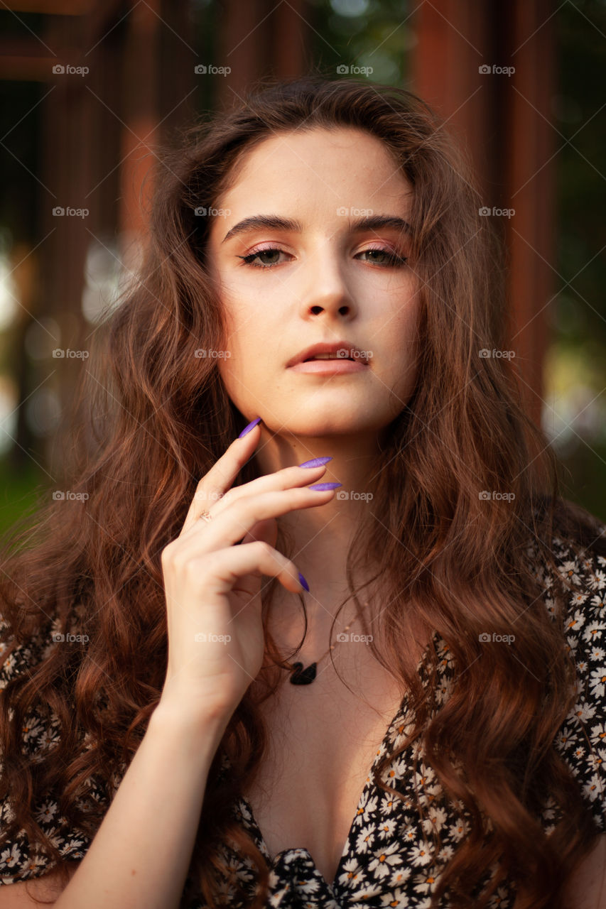 portrait photo of a young woman with bright makeup