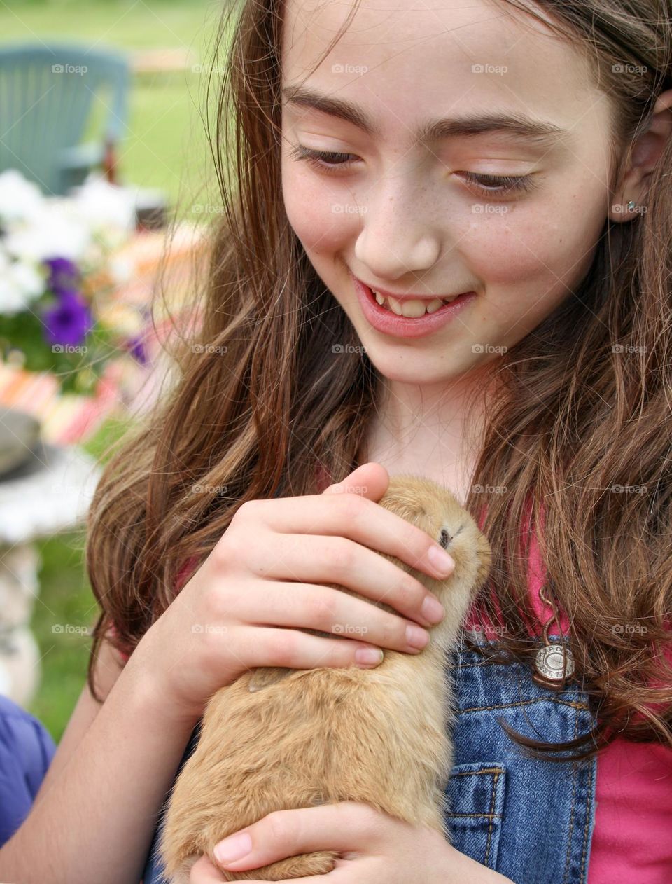 Beautiful girl is holding a bunny