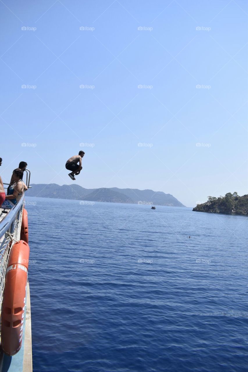 summer fun, jumping off the top of a massive touring boat into the sea