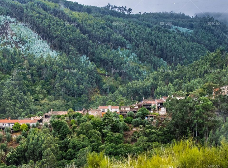 Schist cottages line the hillside, nestled in the mountains at Fragas de São Simão, Figueiró de Vinhos, Portugal 