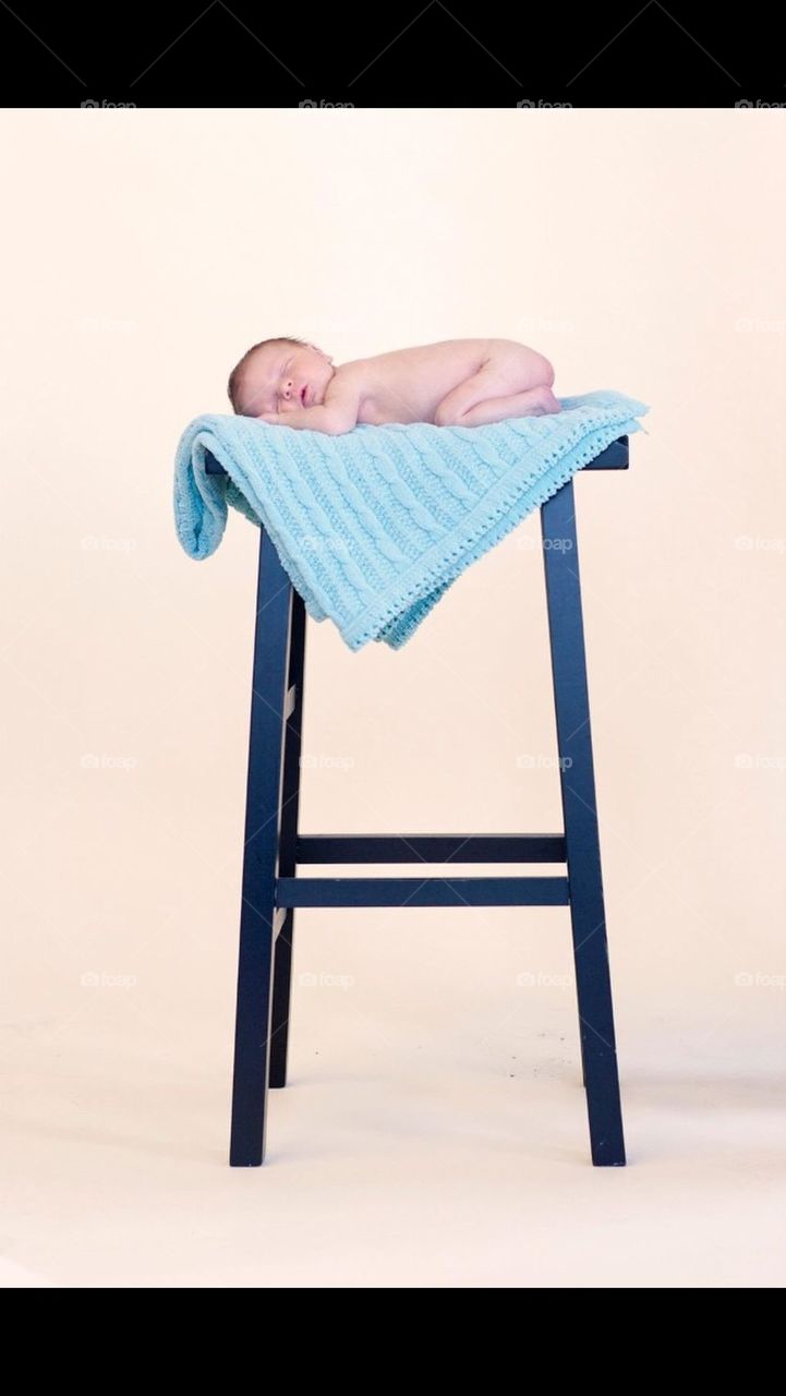 Newborn baby on stool