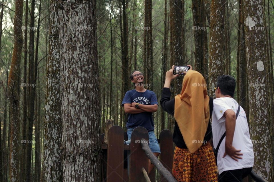 photographing joy and togetherness in a pine forest