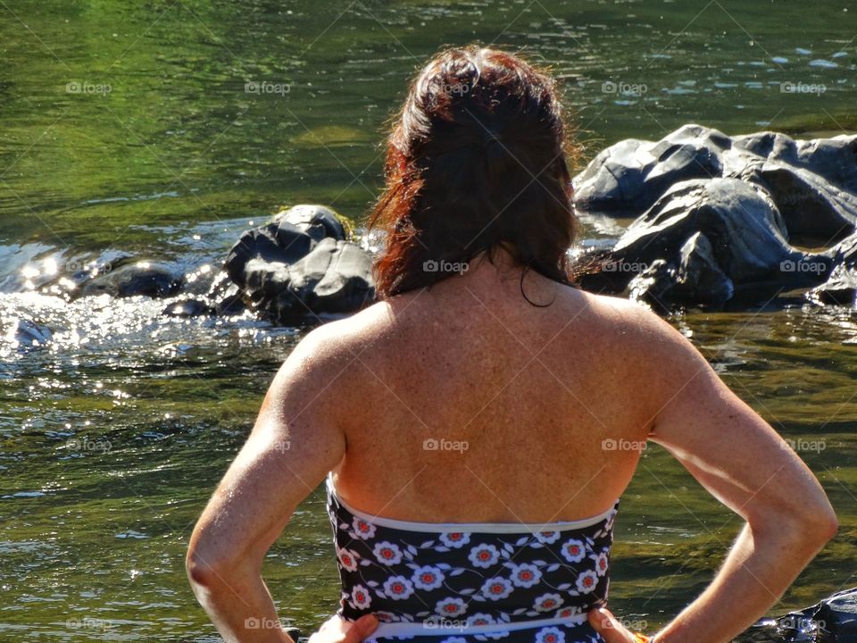 Muscular Female Swimmer. Fit And Toned Muscular Woman Preparing To Swim In A River
