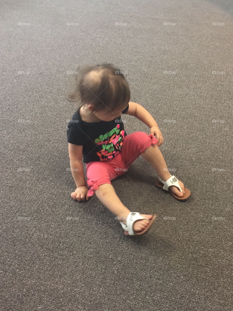 Child sitting on carpet