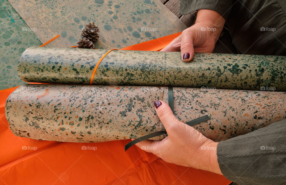 Hands holding papers gift green and orange