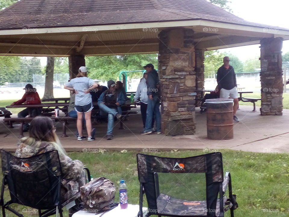 people sitting under the gazebo socializing and anxiously awaiting to eat soon. happy memorial day!