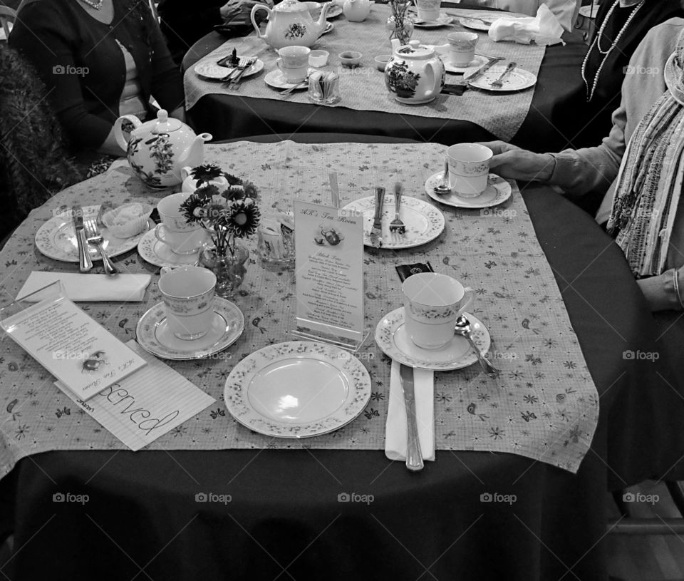 A group of ladies get together for tea and socializing. 