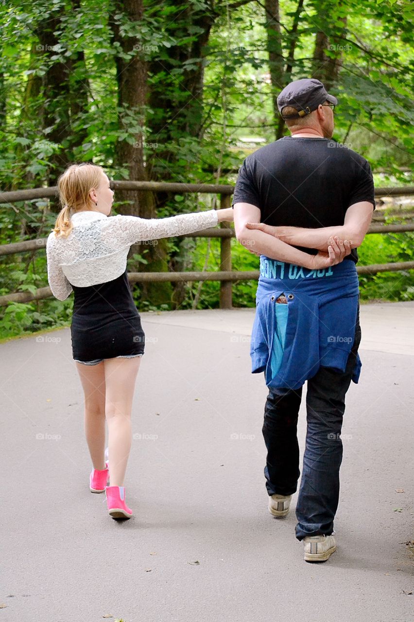 Walking. Father and daughter walking in the park