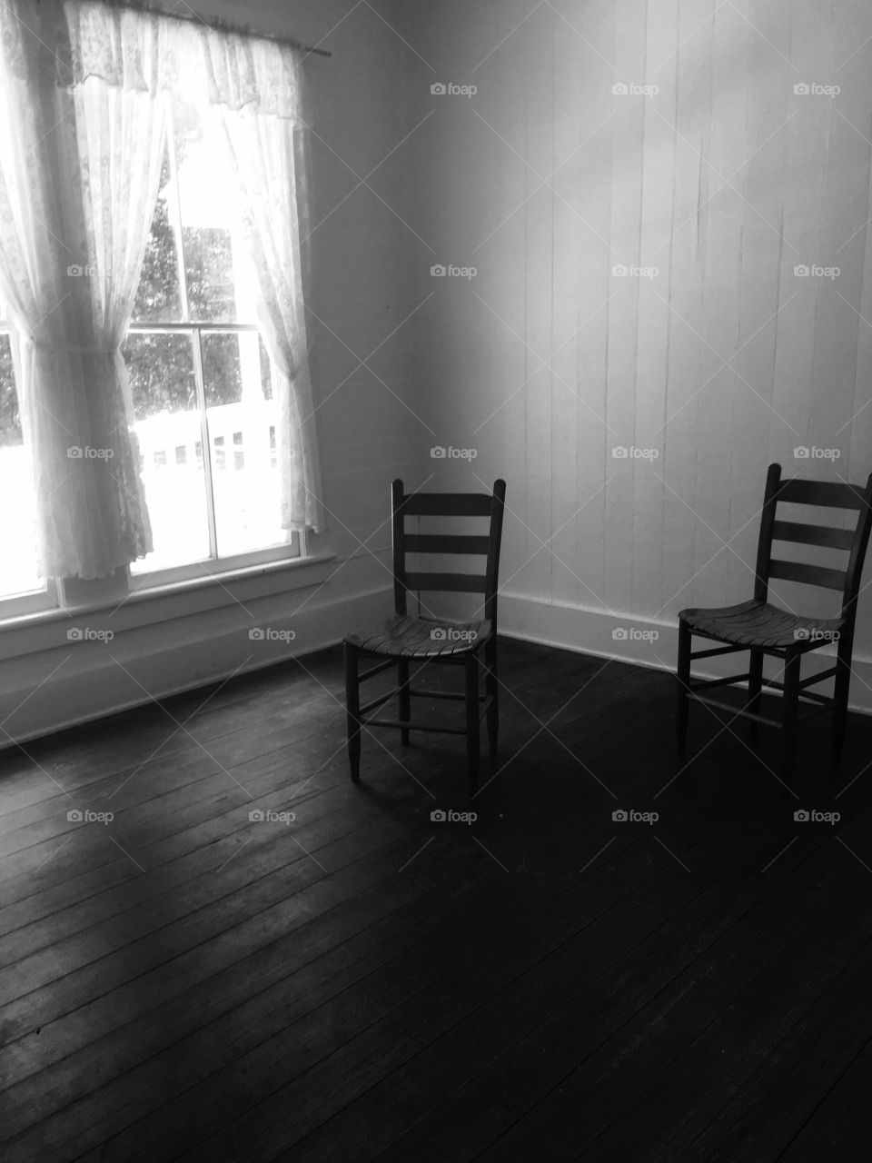 Two chairs to give a creepy vibe with the curtains open