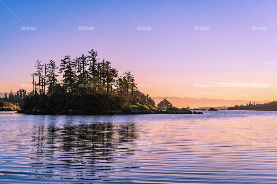 Scenic island under sunset colourful sky