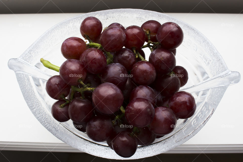 Colorful red grapes in glass bowl 