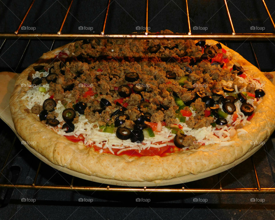 Delicious and nutritious homemade pizza with fresh, colorful vegetables, meats and a variety of spices! Grab a slice!