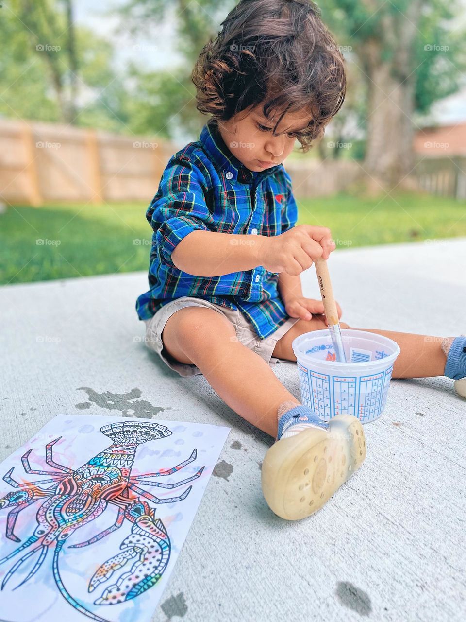 Toddler making a craft, toddler painting outside, art and crafts with a toddler, toddler painting a lobster