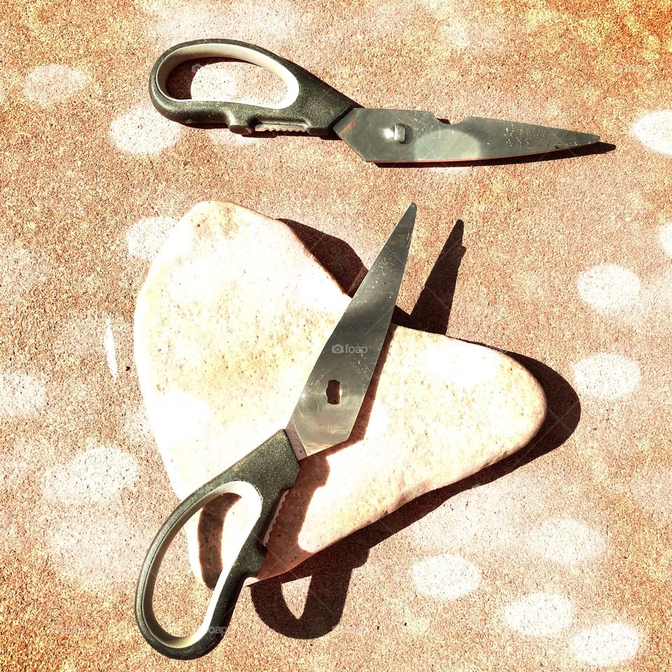 Love conquers all. Heart shaped rock breaking scissors. Rock Paper Scissors