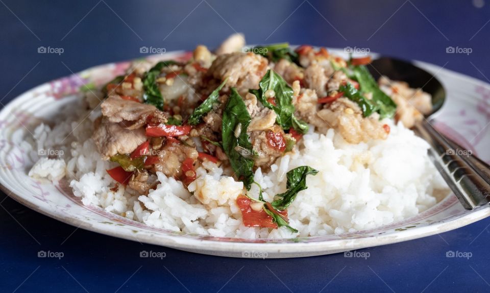 Bangkok/Thailand-Febuary 05 2019:Rice topped with stir-fried pork and basil ,famous Thai food menu