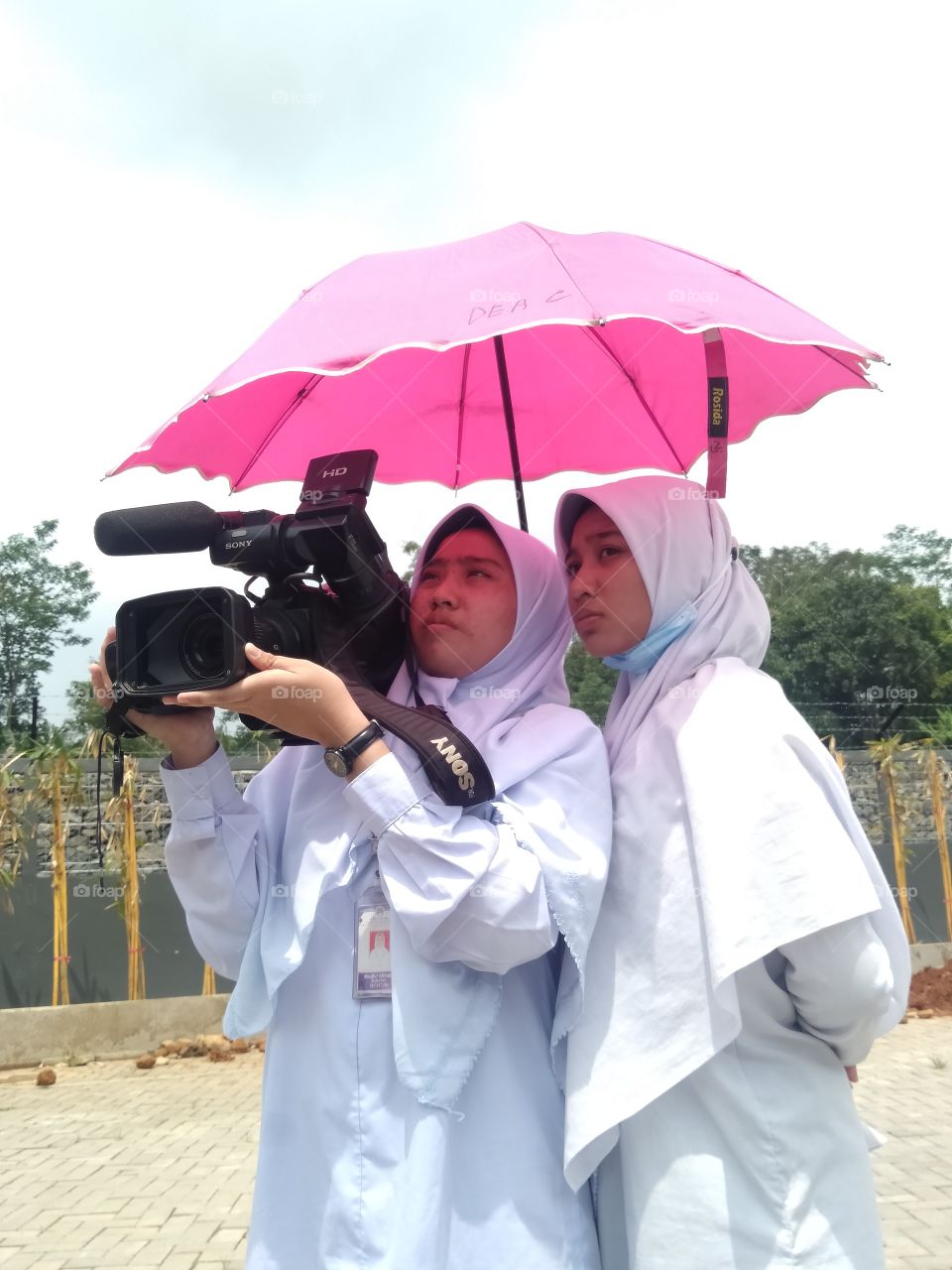 High school students majoring in multimedia are learning how to use an HD camera to take a video of a shot scene