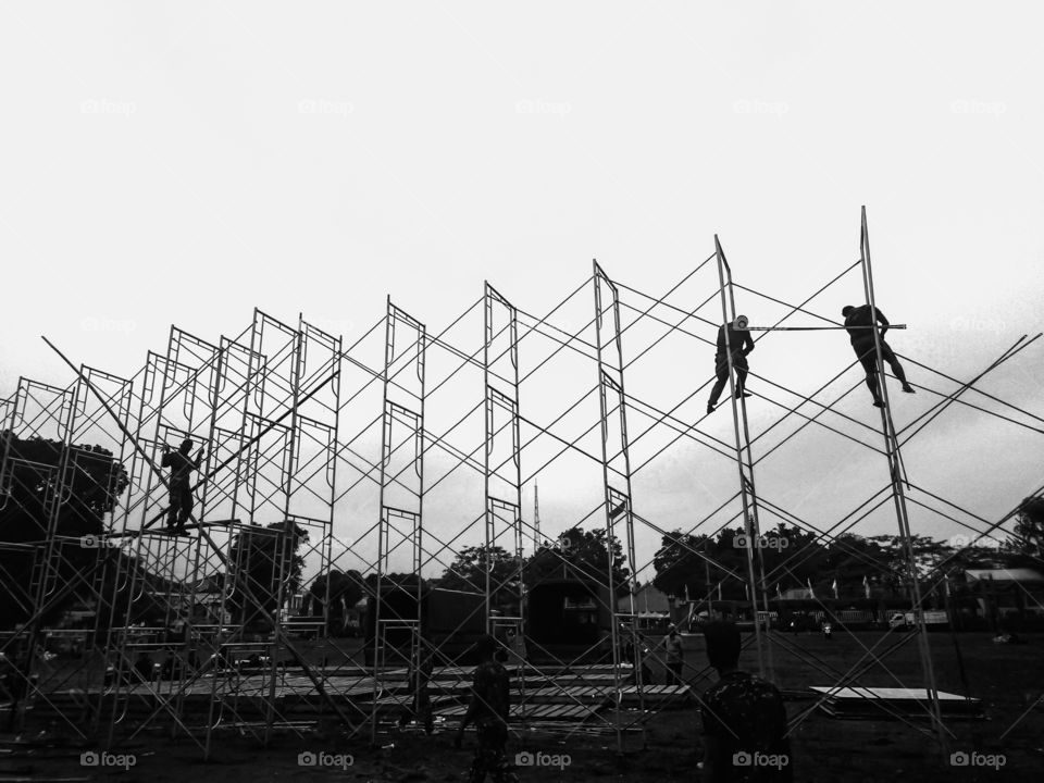 3 man at work build high wall