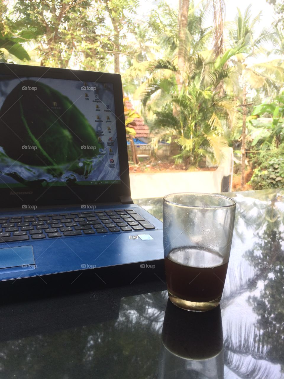 Laptop & a glass which is very cool to look outside with a cup of tea