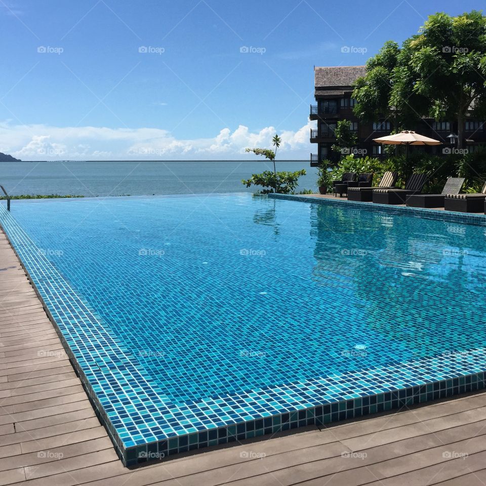 The blue swimming pool under the blue sky