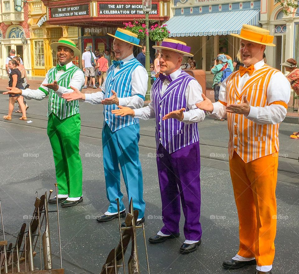 Colorful barbershop quartet singing, dancing and performing on Main Street USA in the Magic Kingdom.  