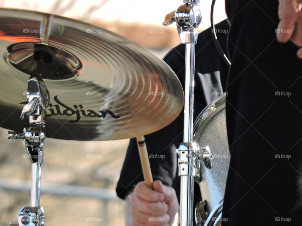 Beat the cymbals!. Drummer playing the drums with cymbals.