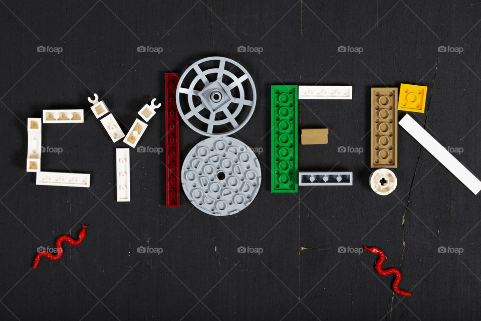 The word CYBER composed og pieces of LEGO. Flat lay