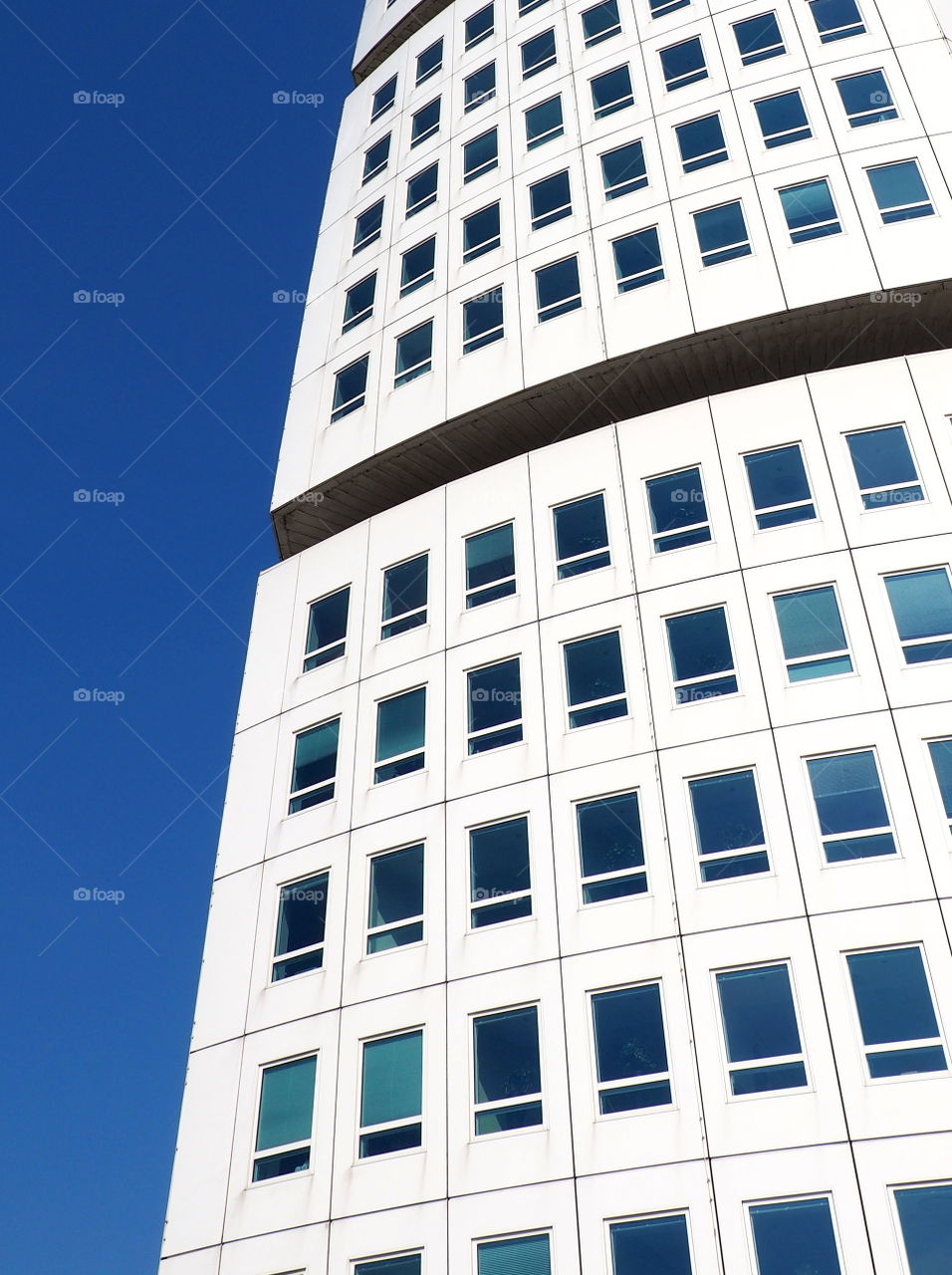 Close-up of the turning torso building in Malmö, Sweden on a sunny day with bright blue sky.