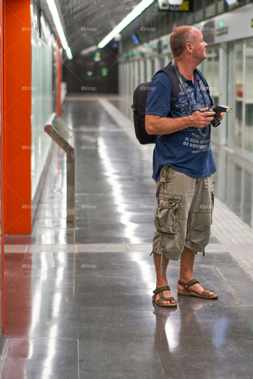 Mature man holding camera in hand
