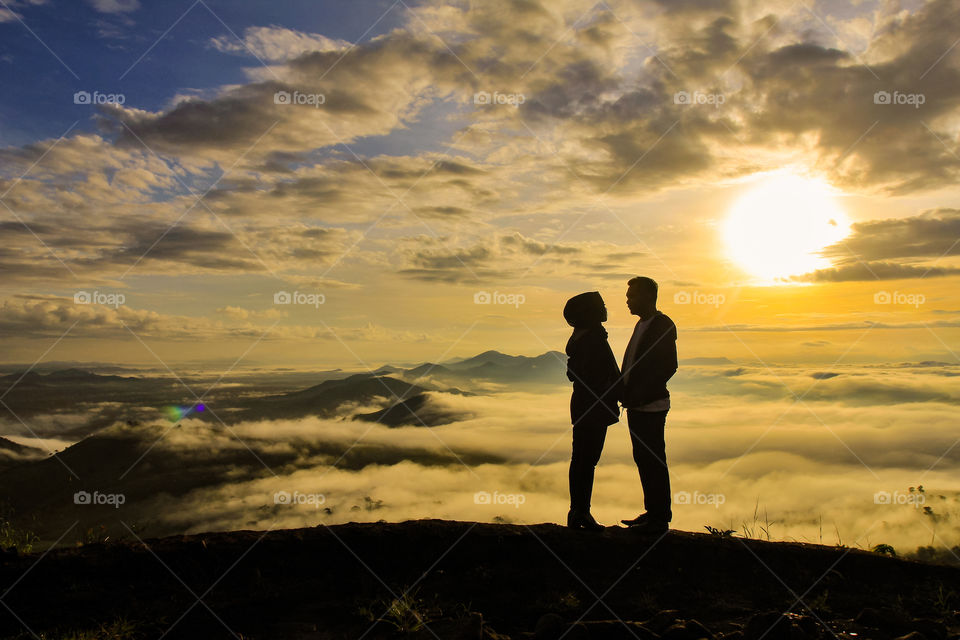 Couple in sunrise at Mandiangin, South Borneo, Indonesia.
