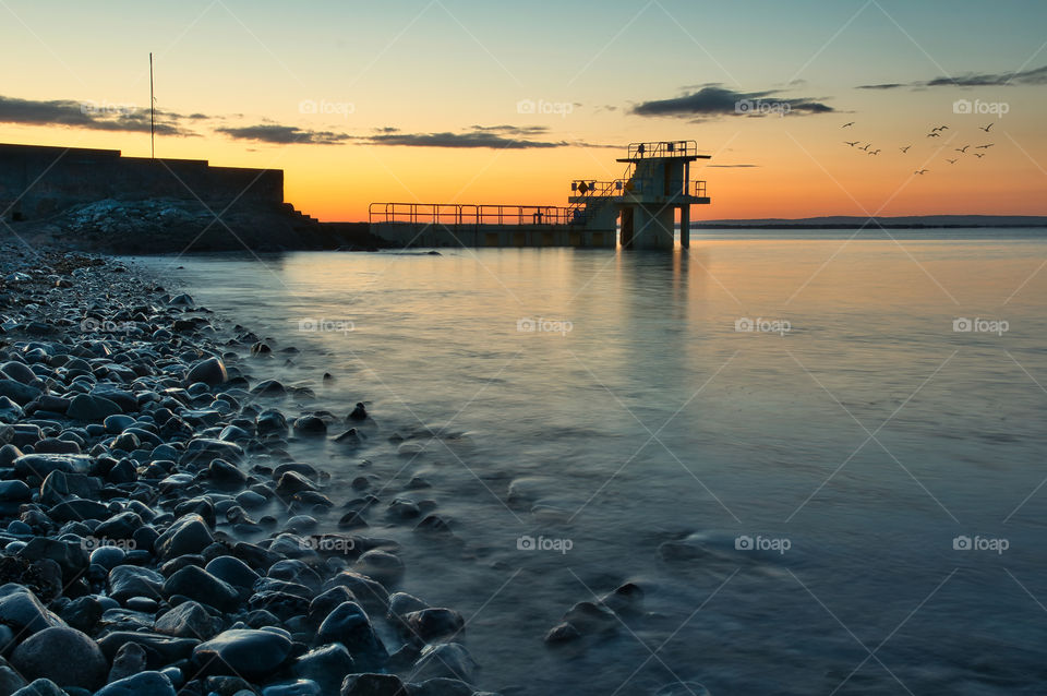 Sunrise at Blacrock diving tower on Salthill beach in Galway, Ireland