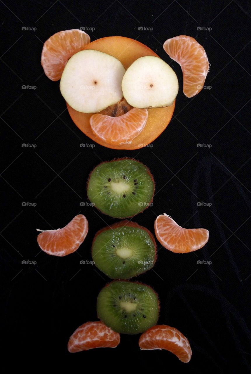Funny face made with fruits slices 