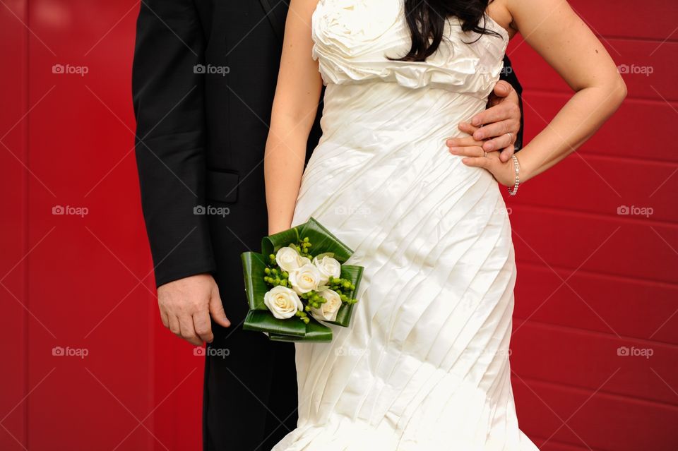 Wedding couple against red background 