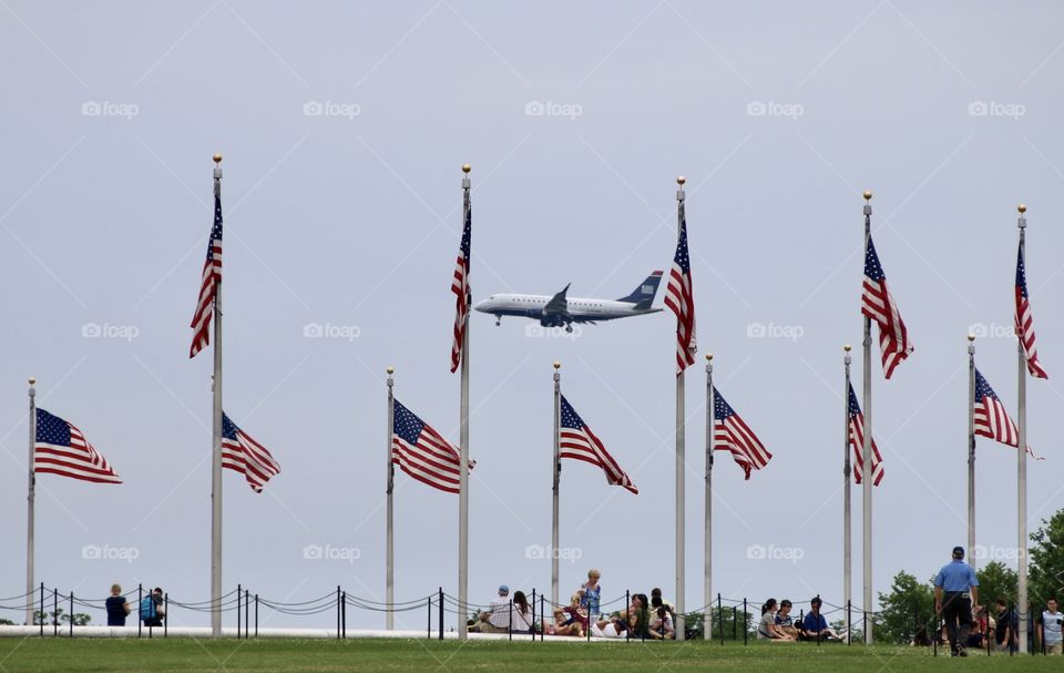 Flags fly around low flying airplane