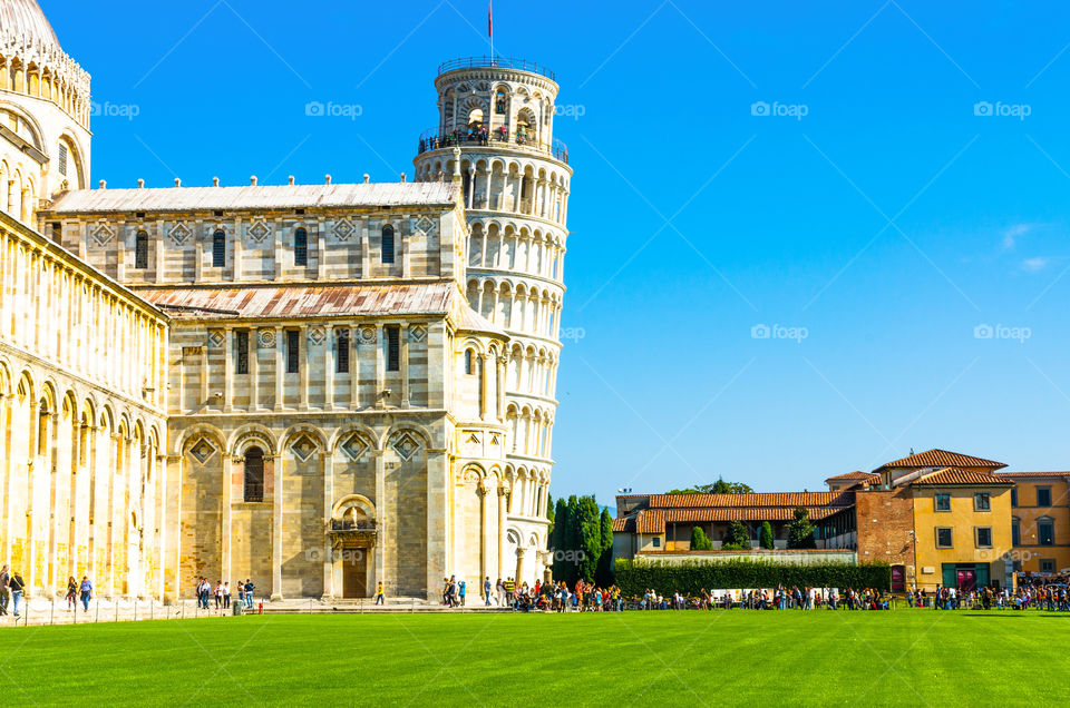 Tourists at the Leaning Tower of Pisa in summer, Tuscany, Italy