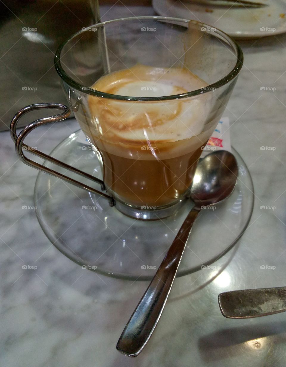 cafe cortado con leche - coffee with milk on the table