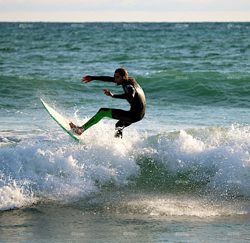Surfing just before sunset at Oceanside Beach, Oceanside, CA.
