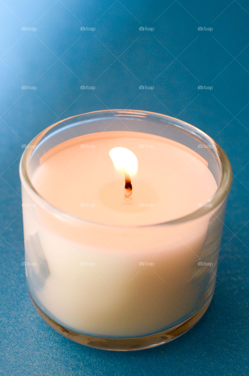 white candle on blue background