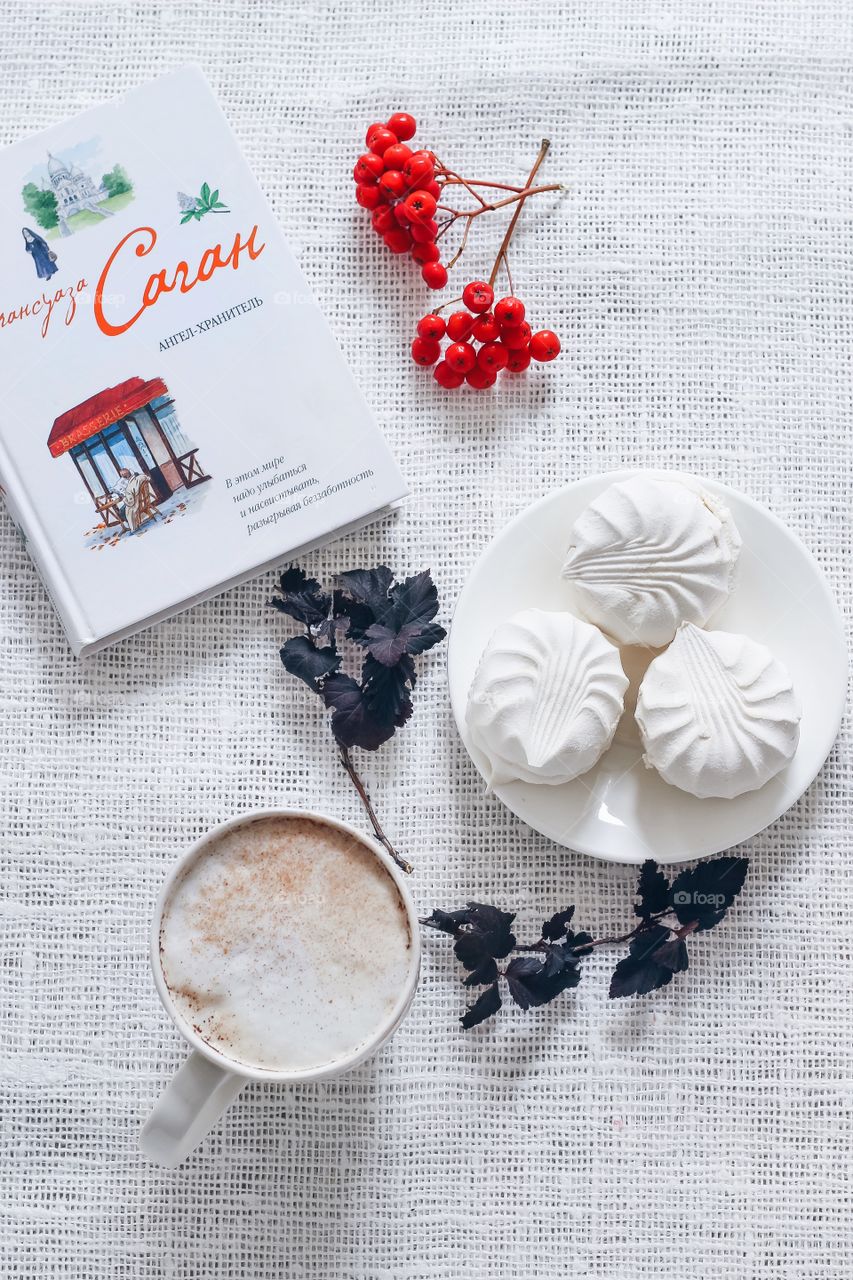 A book and a cup of coffee on the white background 